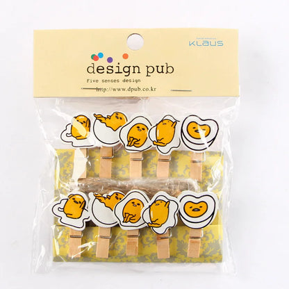 Packaged set of wooden clothespins with cartoon face designs, branded 'design pub'.