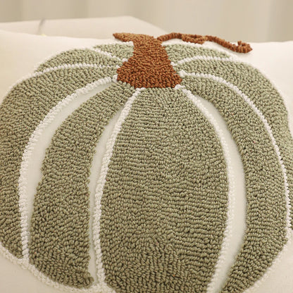 Textured pumpkin-shaped rug with a brown stem on a white background. Festive fall pillow cover for Halloween and Thanksgiving décor