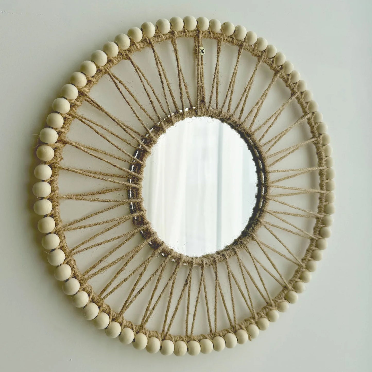 Round mirror with wooden bead and string design on a light gray background Hand-woven Nordic round decorative mirror with Lafite grass frame and hemp rope, boho wall hanging for living room, entryway, or bedroom decor