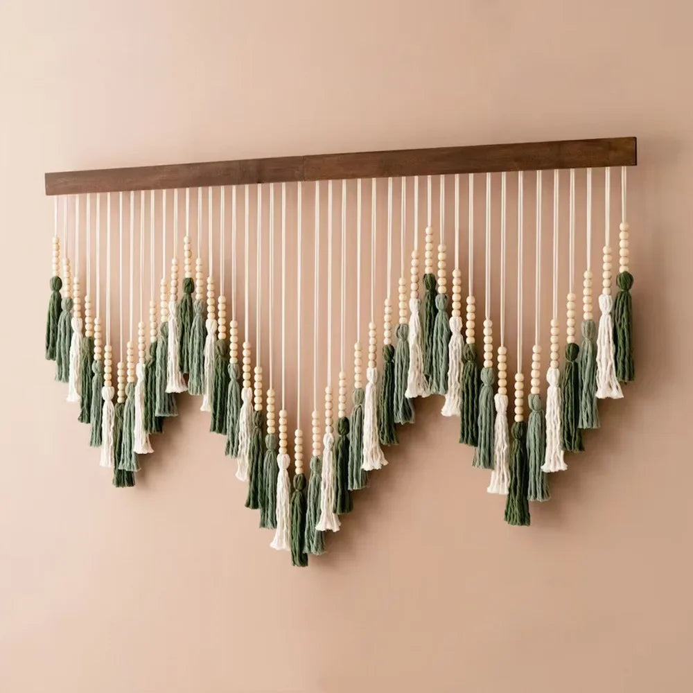Decorative wall hanging with beads and tassels on a beige background