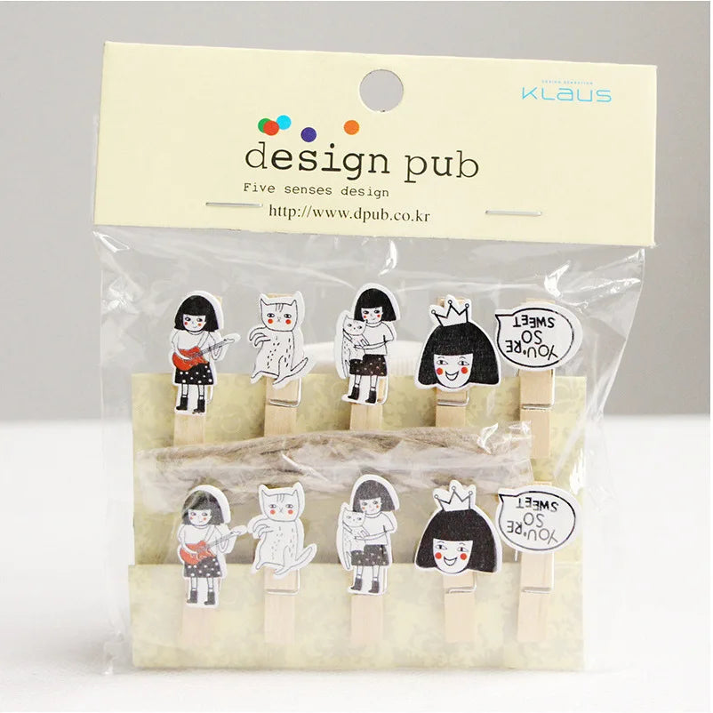 Packaged wooden clips with character designs on a gray background