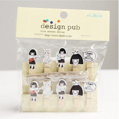 Packaged wooden clips with character designs on a gray background