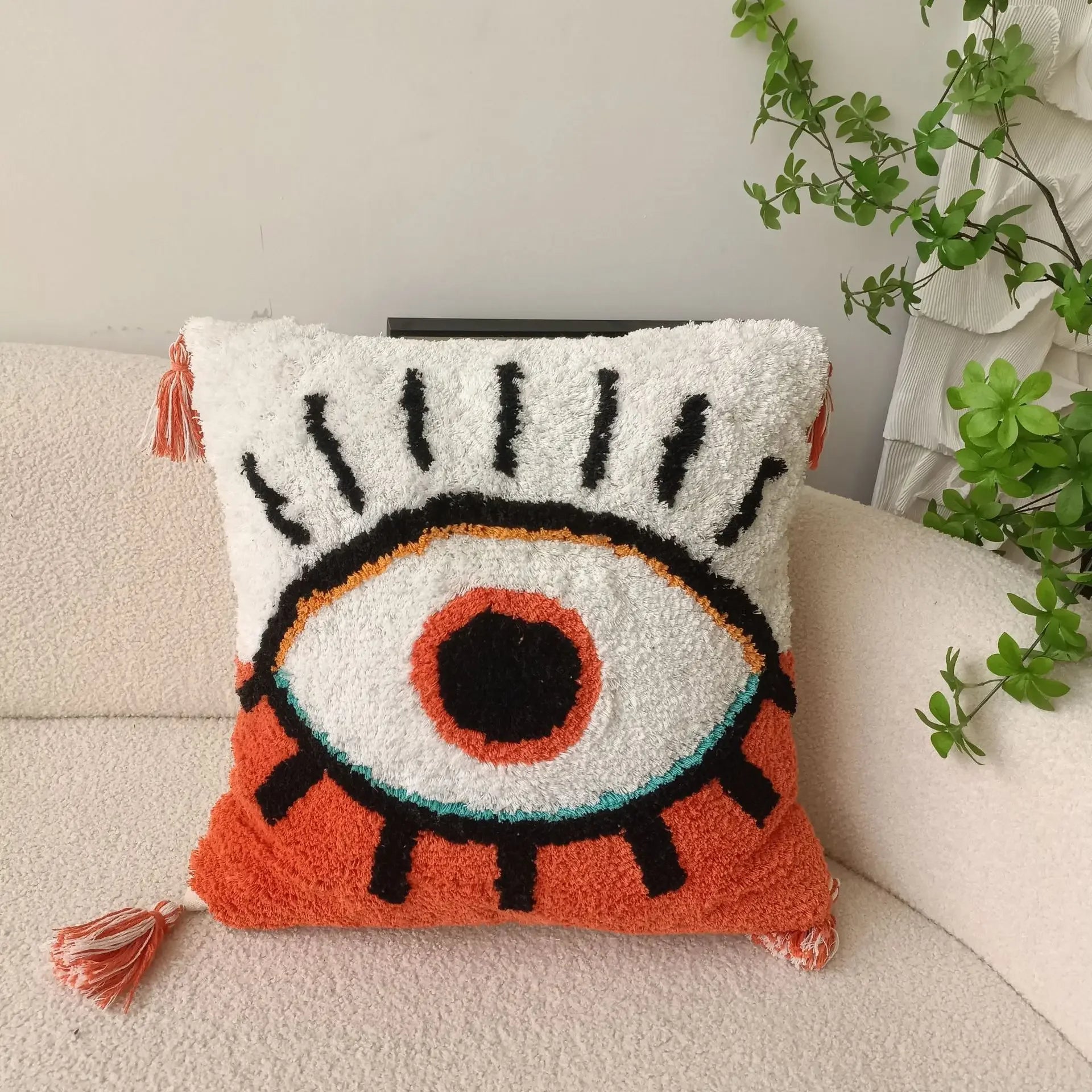 Decorative pillow with eye design on a couch Boho Devil's Eye embroidered pillow cover with tufted geometric design in cotton blend fabric, decorative cushion for sofa, bed, or living room boho home decor.