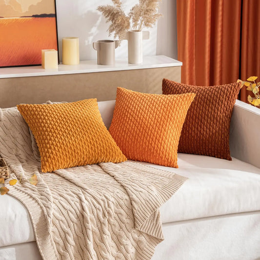 Decorative soft striped boho pillows on a sofa with a neutral color scheme good for fall decor
