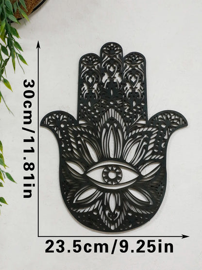 Black hamsa hand-shaped wood wall decor with protective evil eye, photographed against neutral background for alternative boho room styling.