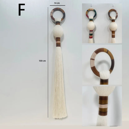 Decorative keychain with tassel and wooden ring on a white background. boho macrame wall art