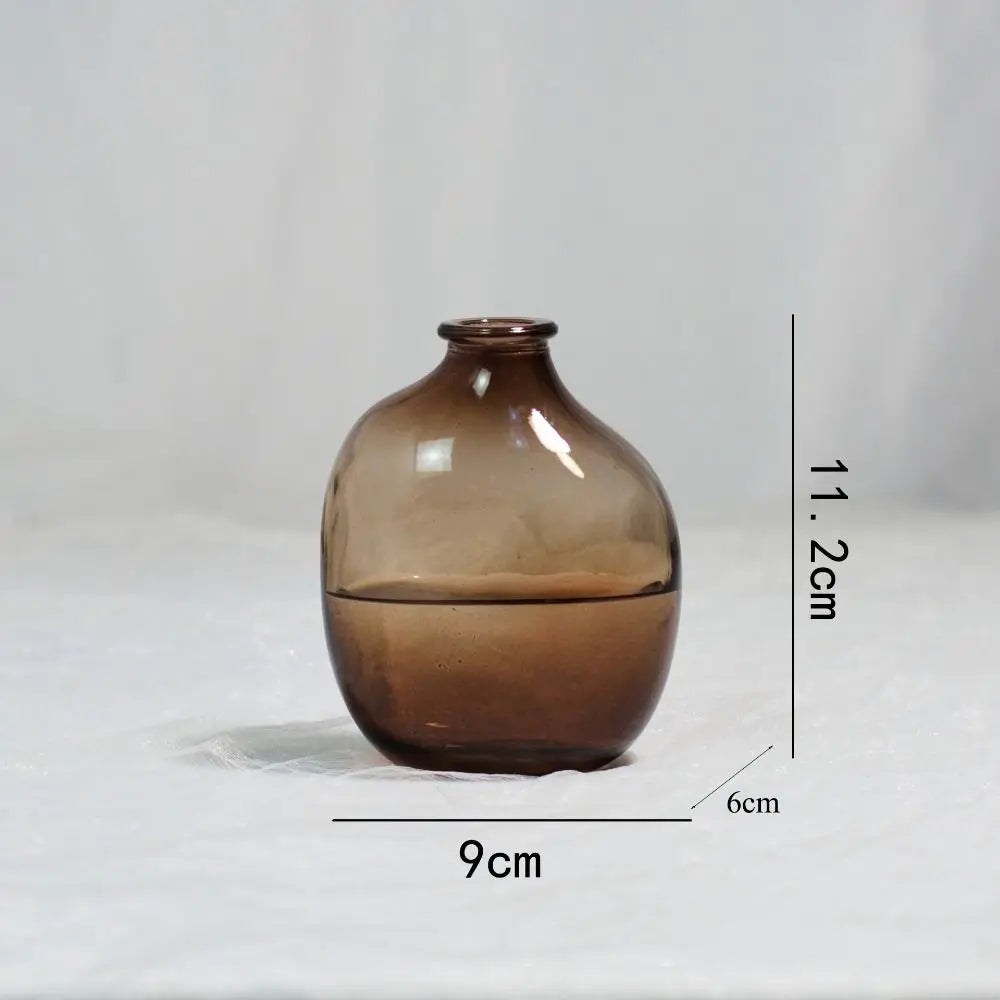 Brown glass vase with measurements on a light gray background