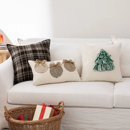 Decorative pillows on a white couch with a wicker basket containing Christmas presents.