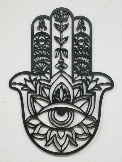 Black hamsa hand-shaped wood wall decor with protective evil eye, photographed against neutral background for alternative boho room styling.