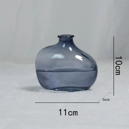 Blue glass vase with measurements on a gray background