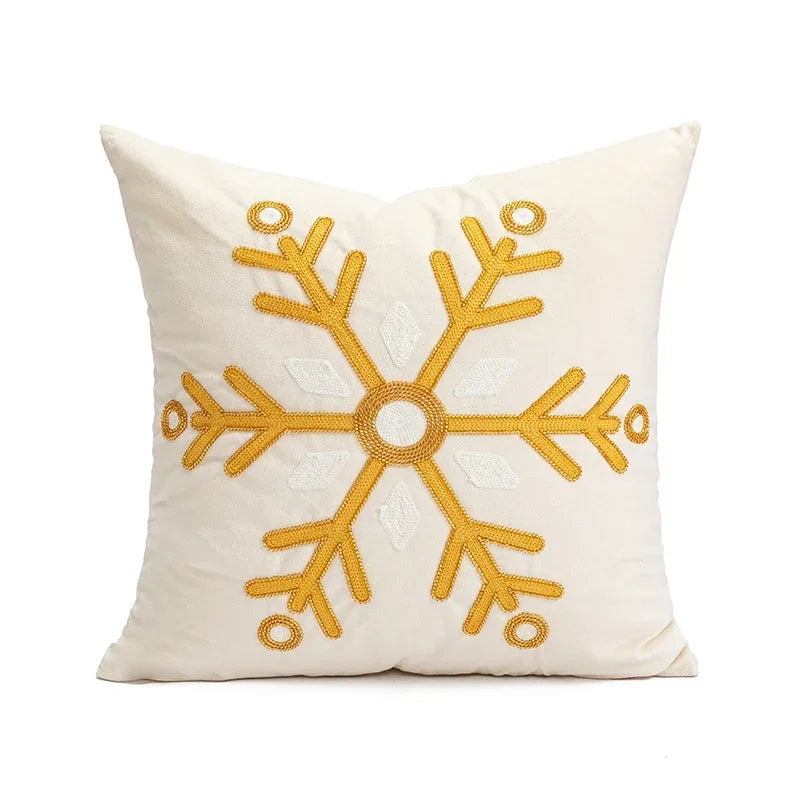 White pillow with a yellow snowflake design on a white background
