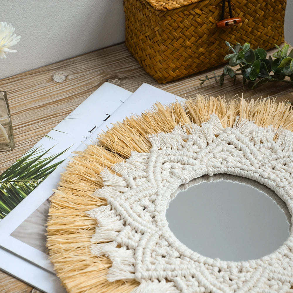 Round mirror with macrame frame on a wooden surface with a woven basket and plant in the background. boho home decor, boho wall mirror, macrame wall mirror, nordic decor, romantic wedding wall decoration, housewarming gift, round straw mirror, woven wall decor, tapestry mirror, boho bedroom wall accent, rustic mirror wall hanging