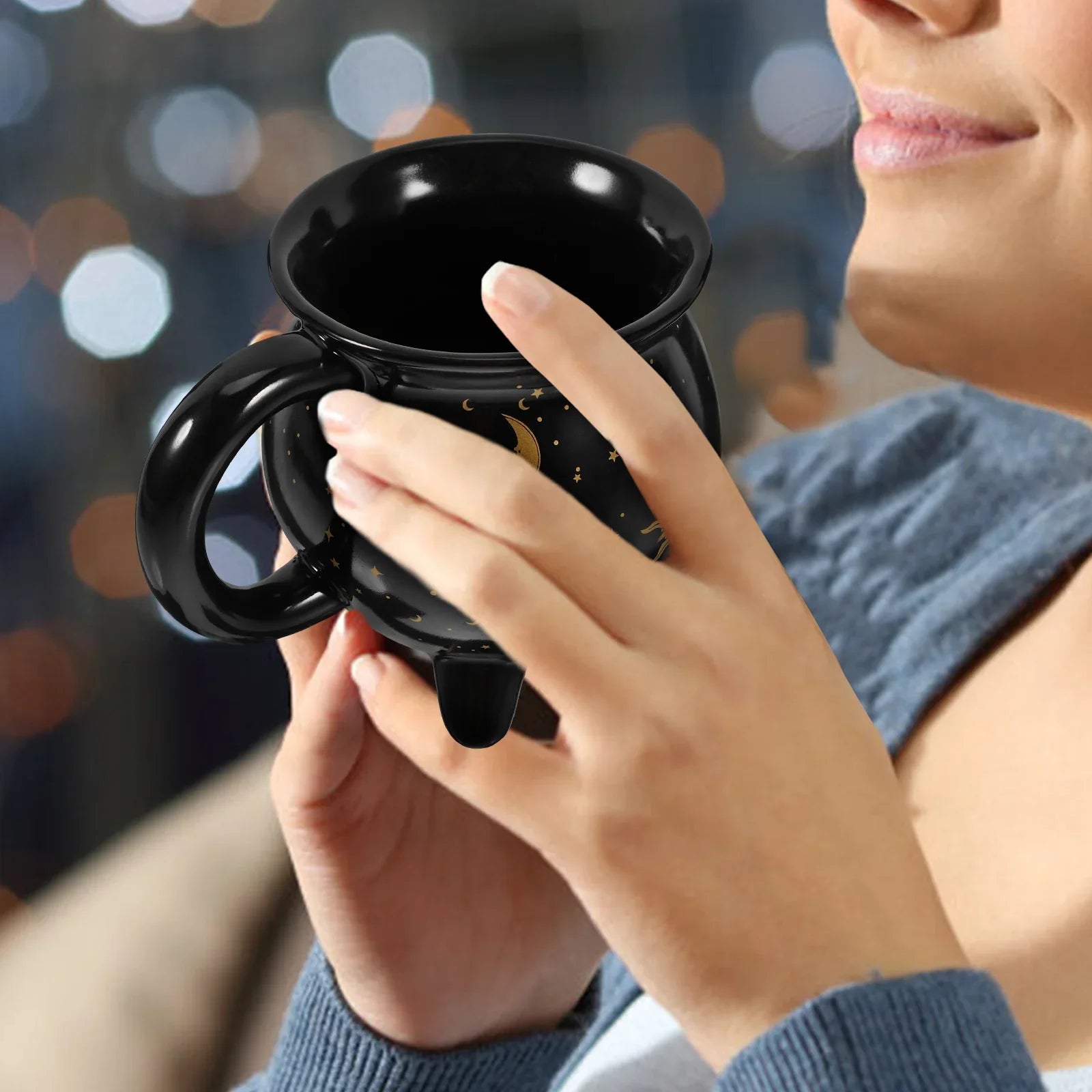 Person holding a black mug with a blurred background boho home decor, witch coffee mug, ceramic cauldron cup, black witch mug, Halloween kitchen decor, spooky housewarming gift, gothic home, potion mug, witchy drinkware, holiday mug for her, cozy boho kitchen accessories
