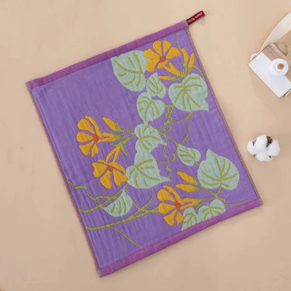 Floral-patterned tea towel on a beige surface