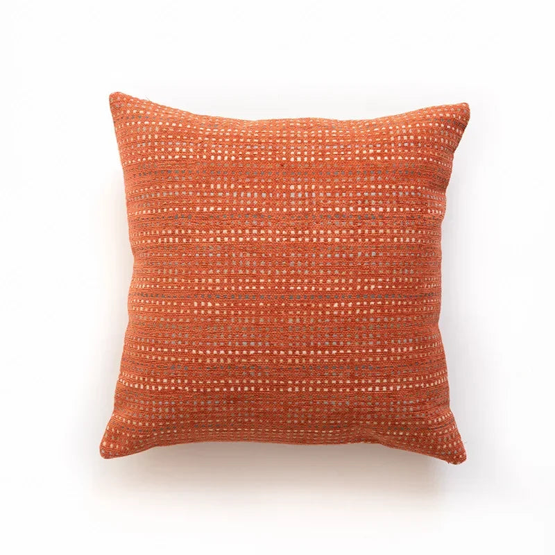 Orange textured pillow on a white background