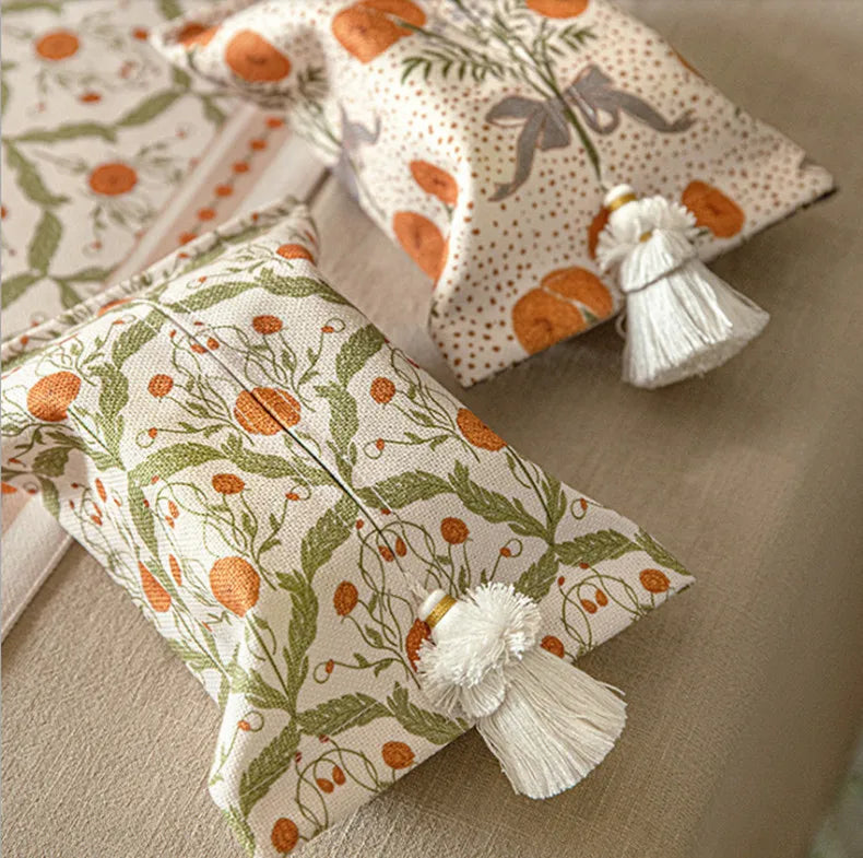 Decorative pillows with floral patterns and tassels on a neutral background boho home decor, reusable tissue bag, cotton tassel tissue holder, plush tissue organizer, bathroom tissue box cover, car tissue case, American style tissue pouch, soft fabric tissue holder, decorative tissue box, housewarming gift, eco-friendly storage