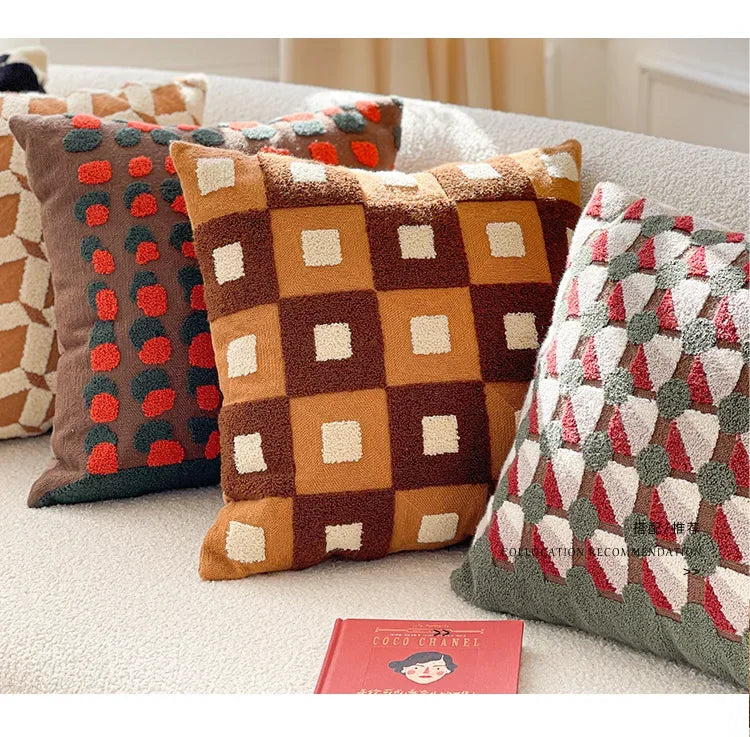 Decorative pillows with geometric patterns on a sofa. Bohemian embroidered throw pillow cover 18x18 inch with geometric towel embroidery, decorative cushion for sofa, bed, or living room boho home decor
