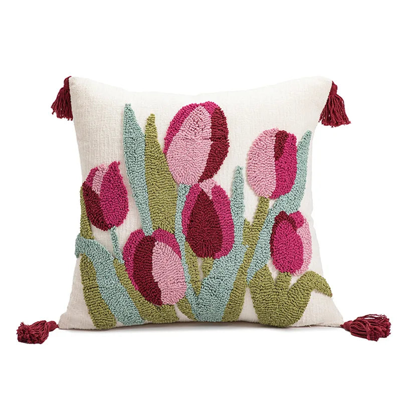 Decorative pillow with pink tulip design on a white background