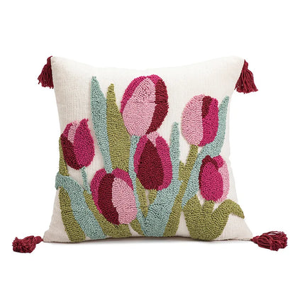 Decorative pillow with pink tulip design on a white background