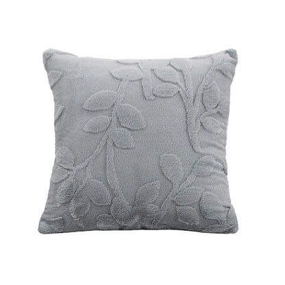 Gray decorative pillow with floral patterns on a white background. Modern jacquard leaf throw pillow cover, woven floral decorative cushion for sofa, bed, or living room in neutral and soft tones.