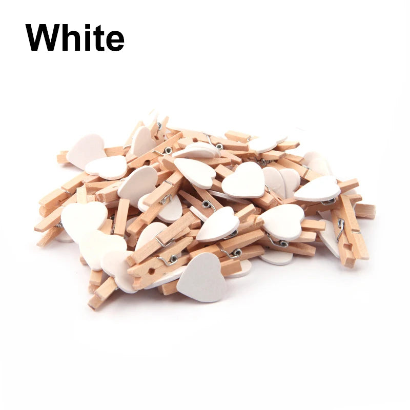 White heart-shaped clothespins on a white background