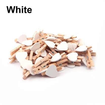 White heart-shaped clothespins on a white background