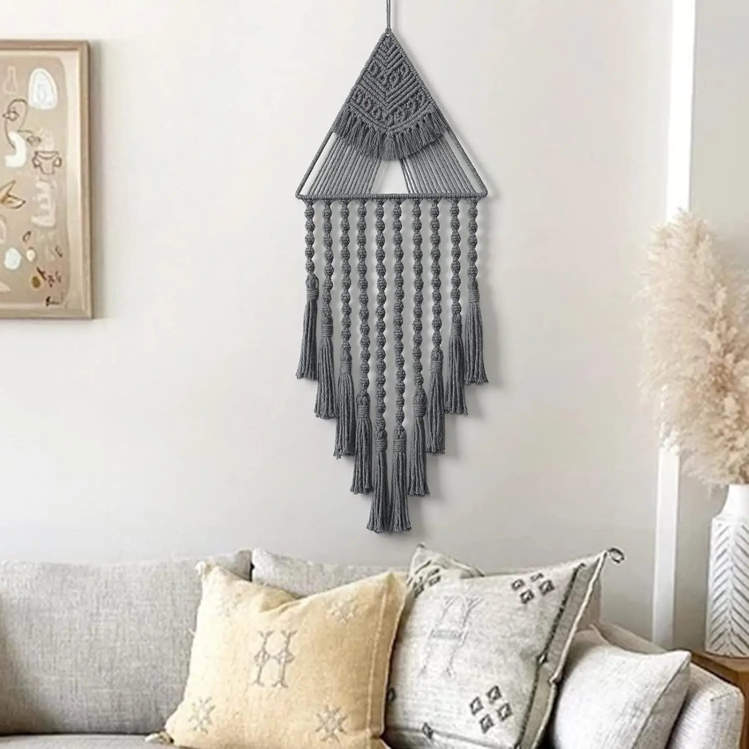 Gray macrame wall hanging above a sofa with decorative pillows boho home decor, macrame wall hanging, triangle dream catcher, woven tapestry, handmade cotton wall decor, tassel wall hanging, bedroom door decor, housewarming gift, rustic bohemian art, boho apartment wall decor, neutral textile art