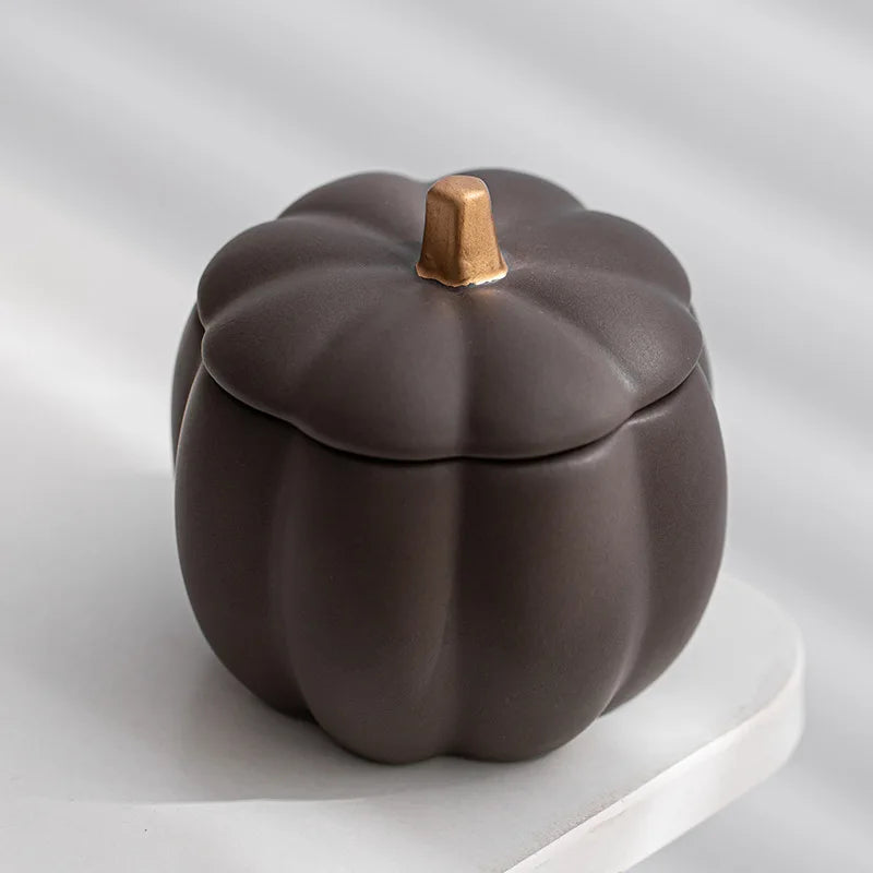 Ceramic pumpkin-shaped container on a light gray background. fall home decor