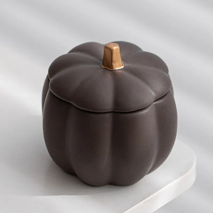 Ceramic pumpkin-shaped container on a light gray background. fall home decor