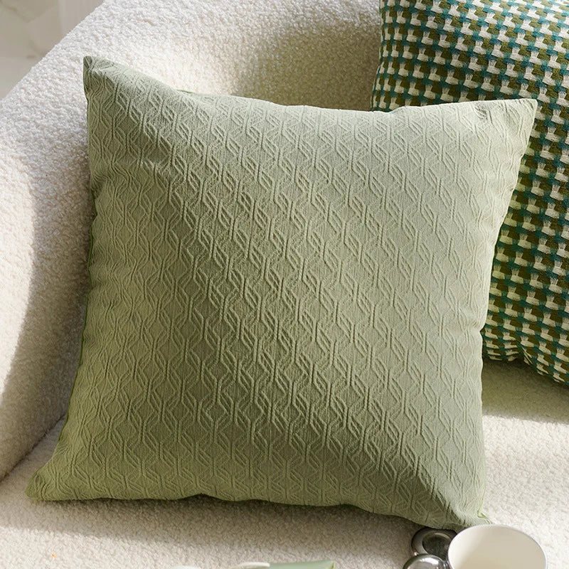 Green textured pillow on a white sofa with another patterned pillow in the background boho home decor, housewarming gift, embroidered pillow cover, flying bird cushion, animal pattern pillowcase, decorative throw pillow, Nordic cushion cover, luxury boho accent, sofa decor, nature-inspired pillow, canvas cushion case, textured home accessories