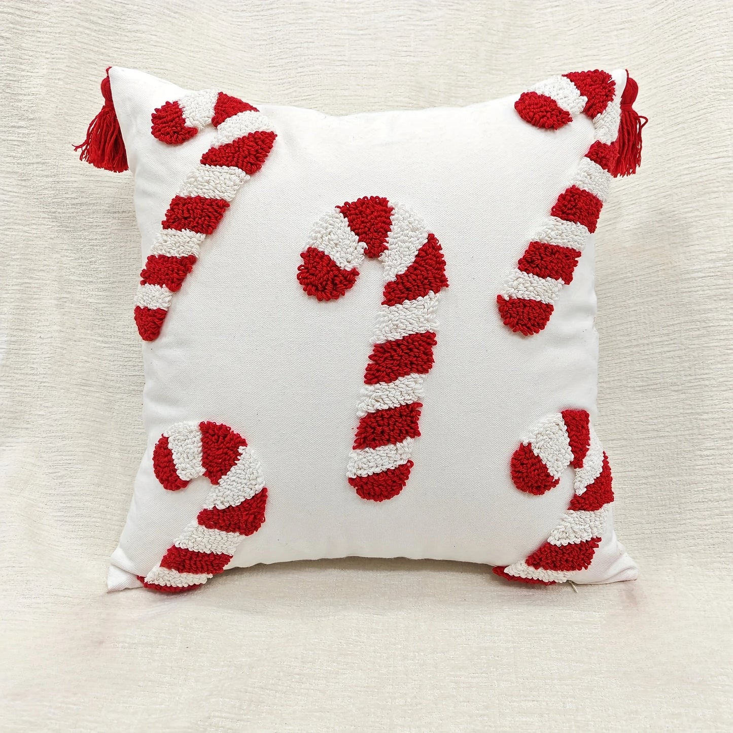 Decorative pillow with candy cane design on a neutral background