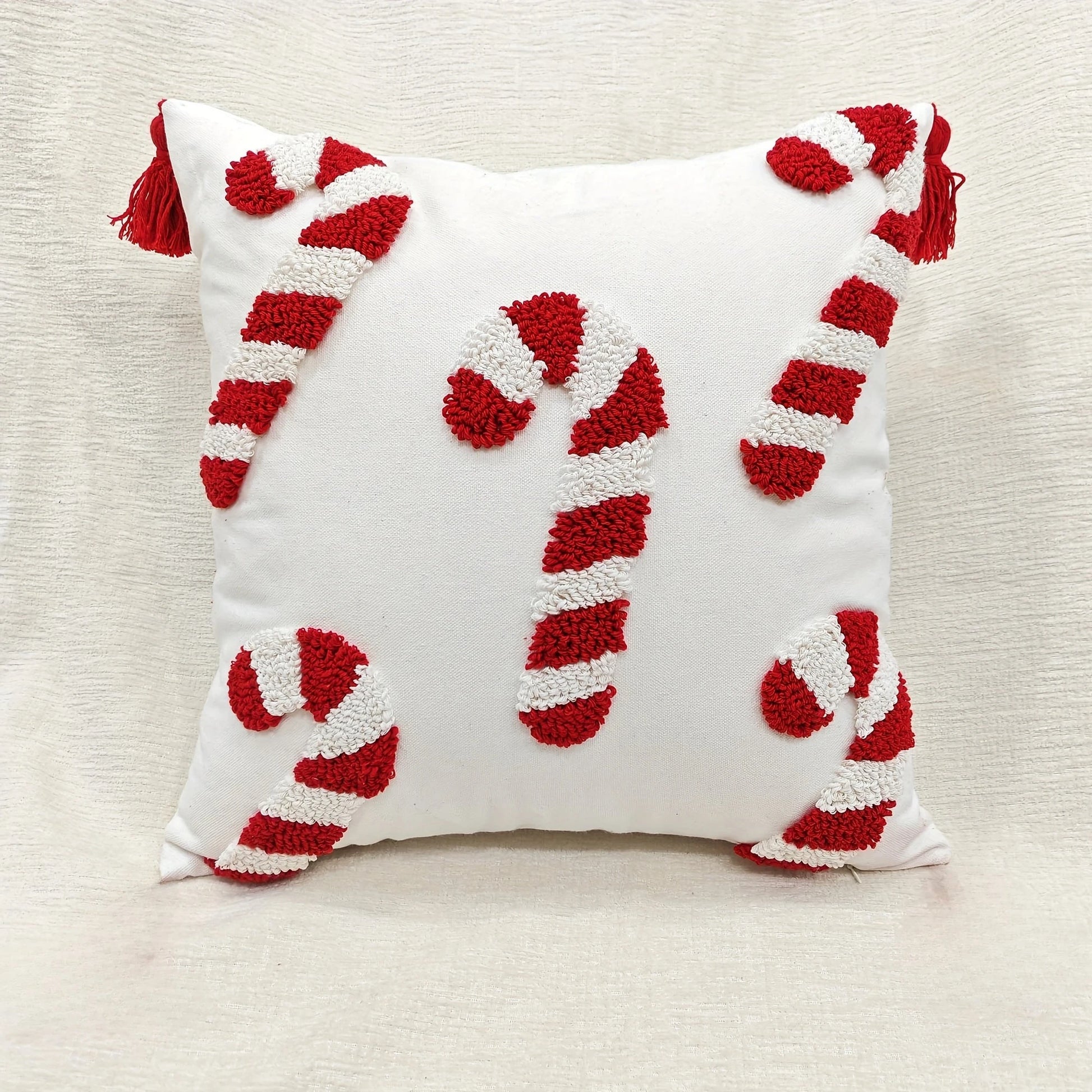 Decorative pillow with candy cane design on a neutral background