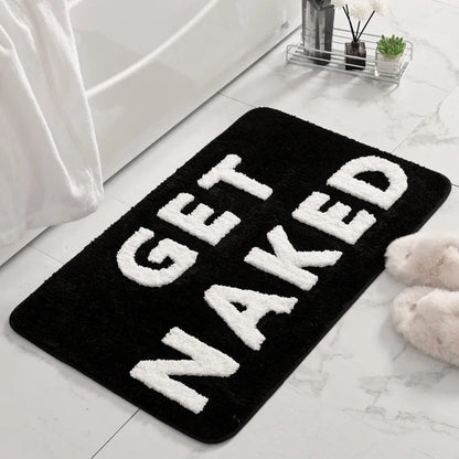Black bath mat with 'GET NAKED' text in a bathroom setting boho home decor, bathroom rug, tufted bath mat, Get Naked rug, colorful shower mat, apartment decor, dorm bathroom accessories, housewarming gift, microfiber bath mat, fun bathroom rug, American style bath mat