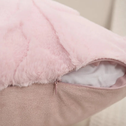 Close-up of a pink plush cushion with a zipper on a neutral background. Modern jacquard leaf throw pillow cover, woven floral decorative cushion for sofa, bed, or living room in neutral and soft tones.