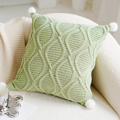 Green knitted pillow with pom-poms on a white couch boho home decor, housewarming gift, embroidered pillow cover, flying bird cushion, animal pattern pillowcase, decorative throw pillow, Nordic cushion cover, luxury boho accent, sofa decor, nature-inspired pillow, canvas cushion case, textured home accessories