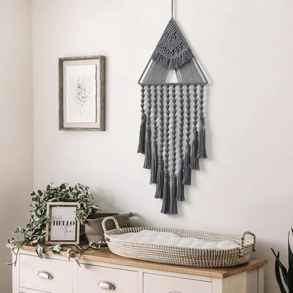 Decorative wall hanging above a dresser with plants and a framed picture. boho home decor, macrame wall hanging, triangle dream catcher, woven tapestry, handmade cotton wall decor, tassel wall hanging, bedroom door decor, housewarming gift, rustic bohemian art, boho apartment wall decor, neutral textile art