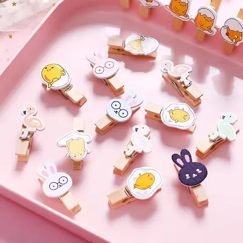 Set of decorative clothespins with animal designs on a pink tray.