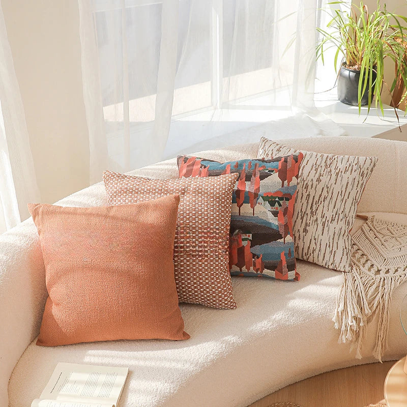 Decorative pillows on a beige sofa with a neutral background. Modern yarn-dyed throw pillow cover, luxury textured decorative cushion for sofa, bed, or window seating in soft neutral tones.