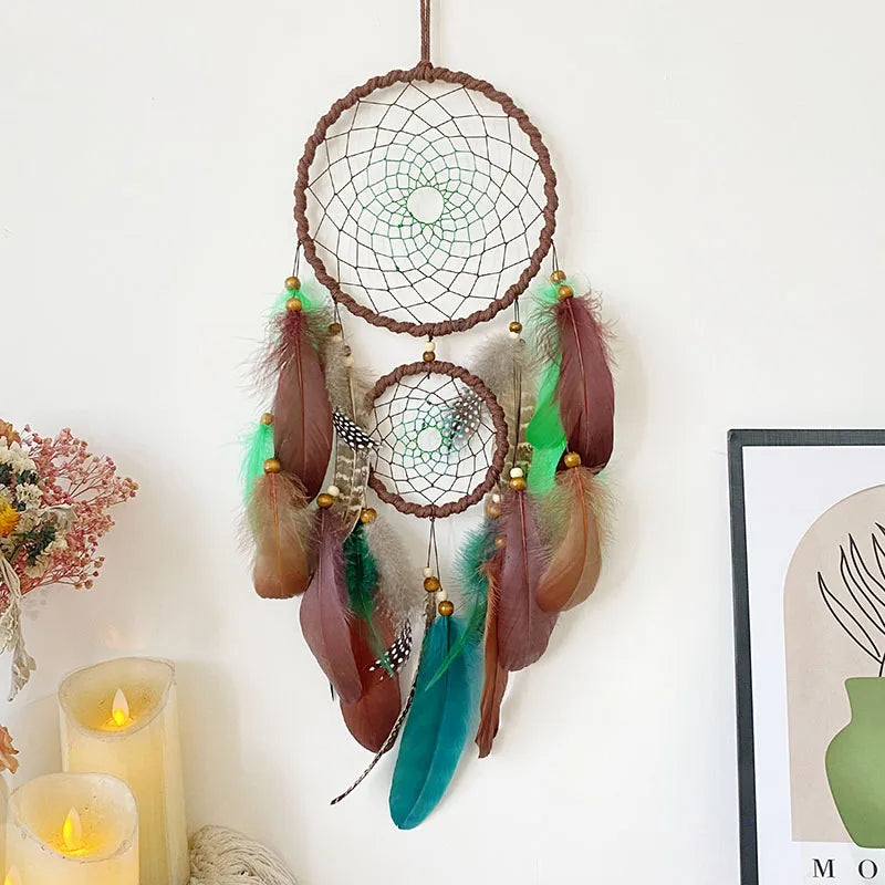Dreamcatcher with feathers hanging on a white wall with candles and decor. boho home decor, housewarming gift, dream catcher wall hanging, feather wind chime, handmade dreamcatcher, colorful boho wall decor, birthday gift decor, modern bohemian style, bedroom hanging ornament, spiritual home decor, dreamcatcher nursery decor