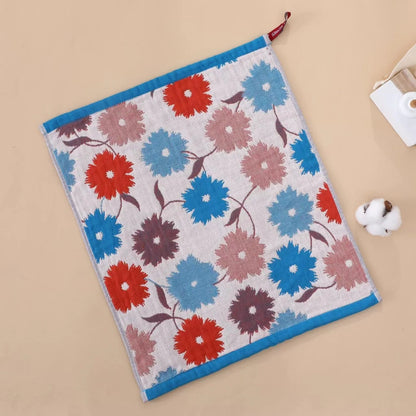 Floral patterned tea towel with red, blue, and pink flowers on a beige background