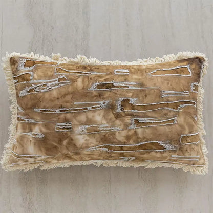 Decorative pillow with textured surface and fringes on a neutral background. embroidery throw pillow cover in boho modern style