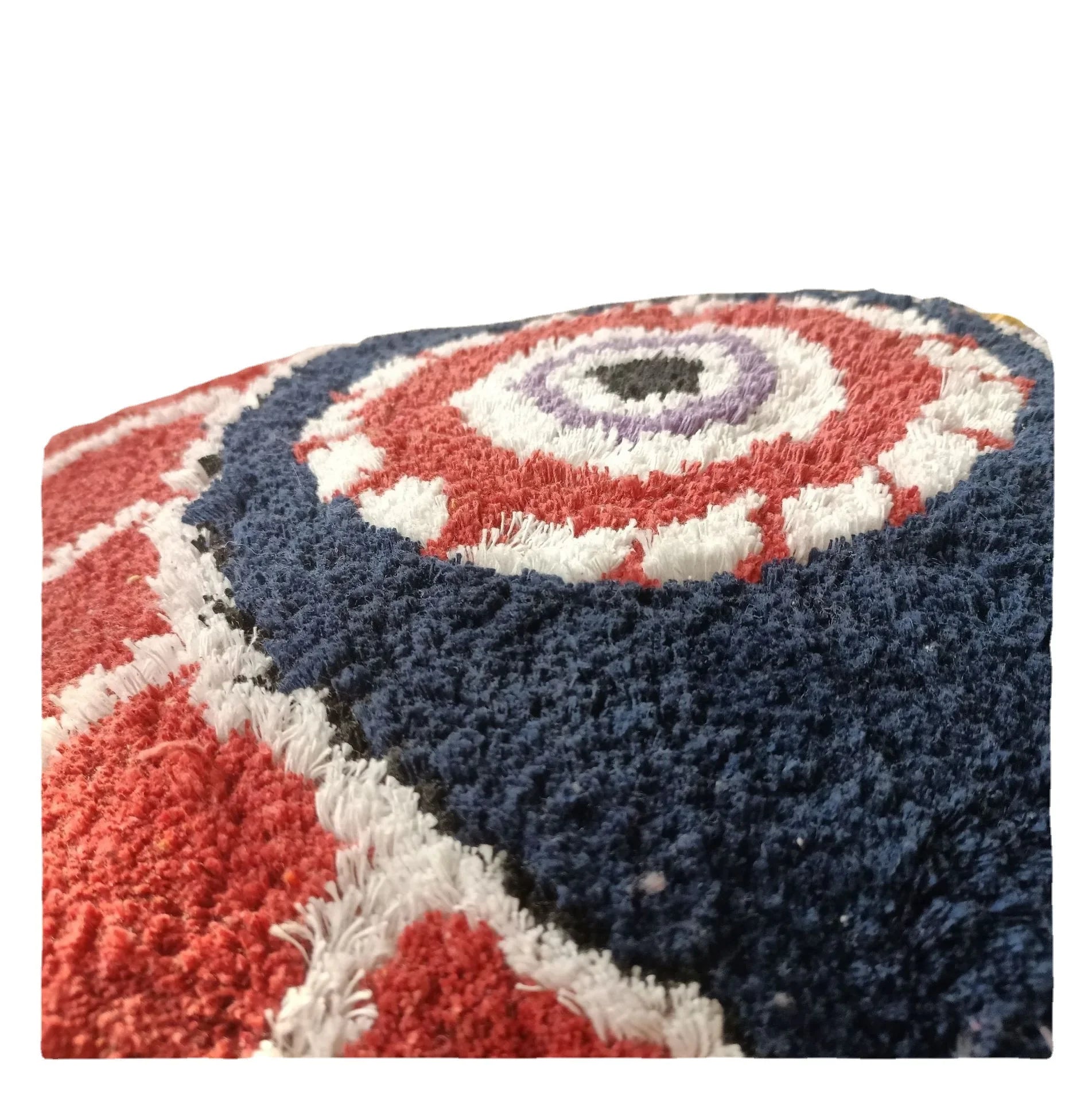 Close-up of a textured fabric roll with red, white, and blue patterns on a white background. Boho Devil's Eye embroidered pillow cover with tufted geometric design in cotton blend fabric, decorative cushion for sofa, bed, or living room boho home decor.