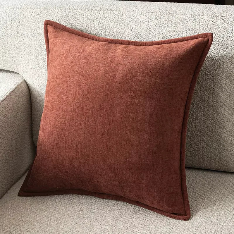 Brown pillow on a beige sofa