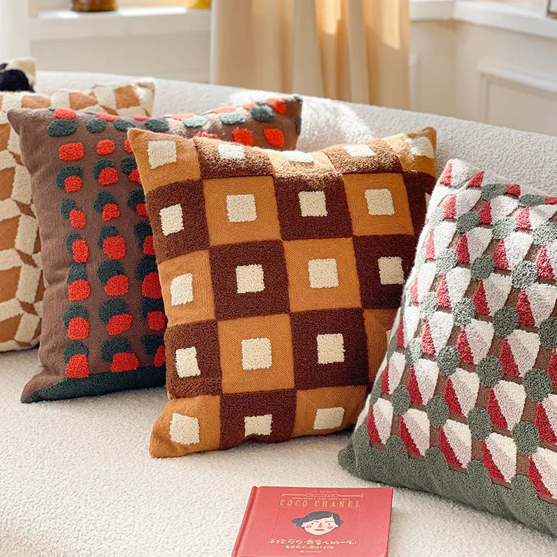 Decorative pillows with geometric patterns on a sofa. Bohemian embroidered throw pillow cover 18x18 inch with geometric towel embroidery, decorative cushion for sofa, bed, or living room boho home decor