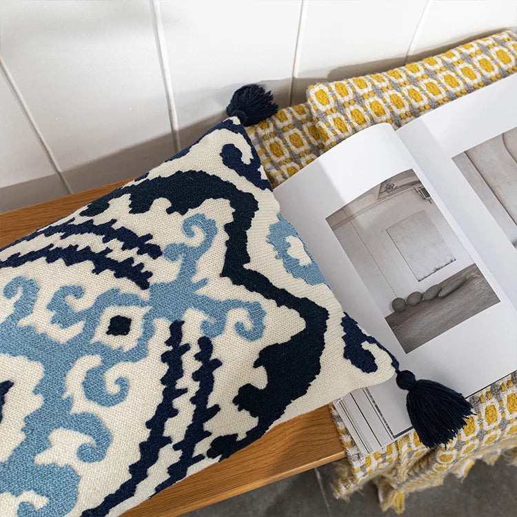 Decorative rug with intricate patterns on a wooden surface. Bohemian embroidered throw pillow cover with geometric design, cotton-blend cushion for sofa, bed, or modern home decor.