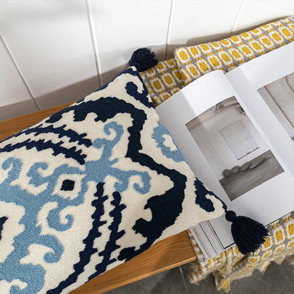 Decorative rug with intricate patterns on a wooden surface. Bohemian embroidered throw pillow cover with geometric design, cotton-blend cushion for sofa, bed, or modern home decor.