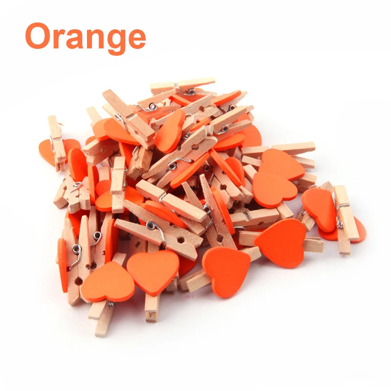 Pile of orange and wooden heart-shaped clips on a white background with 'Orange' text above.
