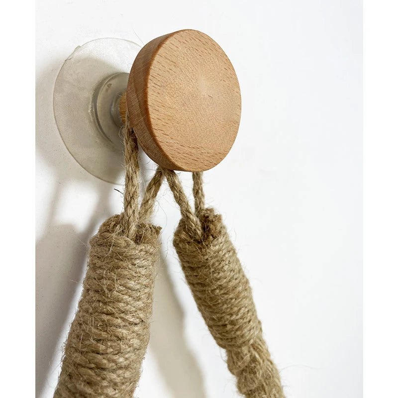 Wooden wall hook with jute ropes on a white background. Boho rope toilet paper holder, nail-free wall mounted paper towel rack, rustic bathroom storage and decor accessory with wood and rope design