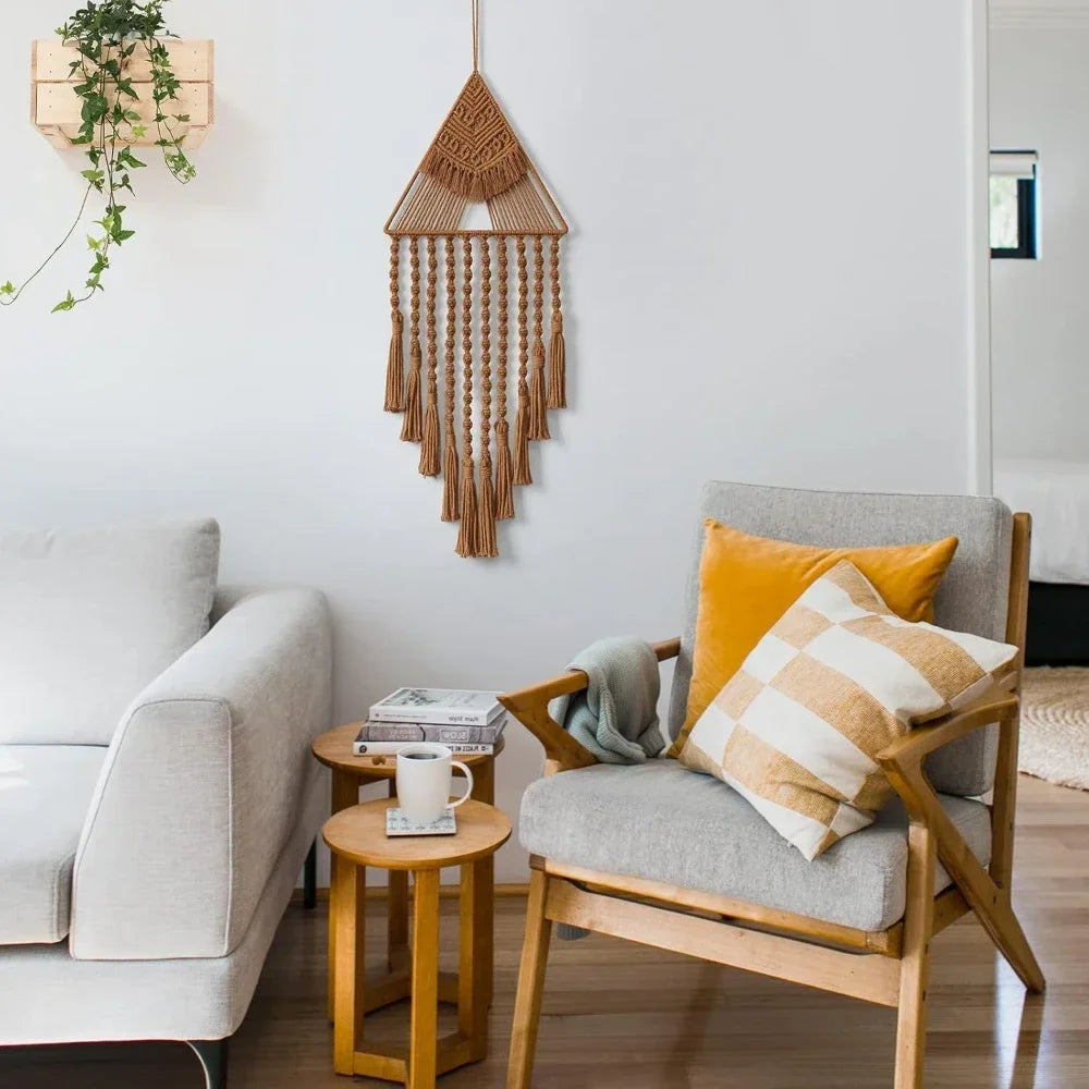 Living room with a chair, sofa, and decorative wall hanging. boho home decor, macrame wall hanging, triangle dream catcher, woven tapestry, handmade cotton wall decor, tassel wall hanging, bedroom door decor, housewarming gift, rustic bohemian art, boho apartment wall decor, neutral textile art