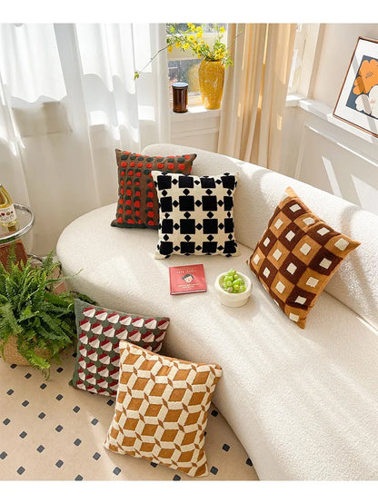 Decorative pillows on a white sofa with a homey decor setting. Bohemian embroidered throw pillow cover 18x18 inch with geometric towel embroidery, decorative cushion for sofa, bed, or living room boho home decor